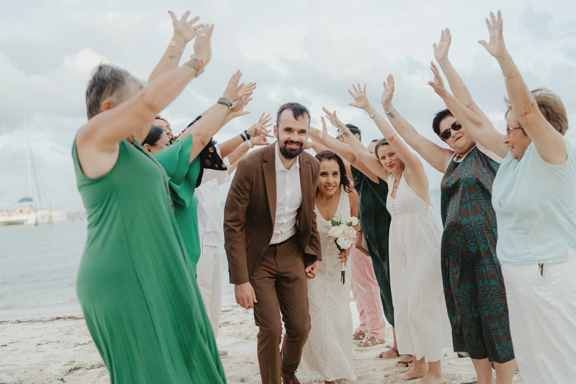 Couple celebrating with their guests on the beach