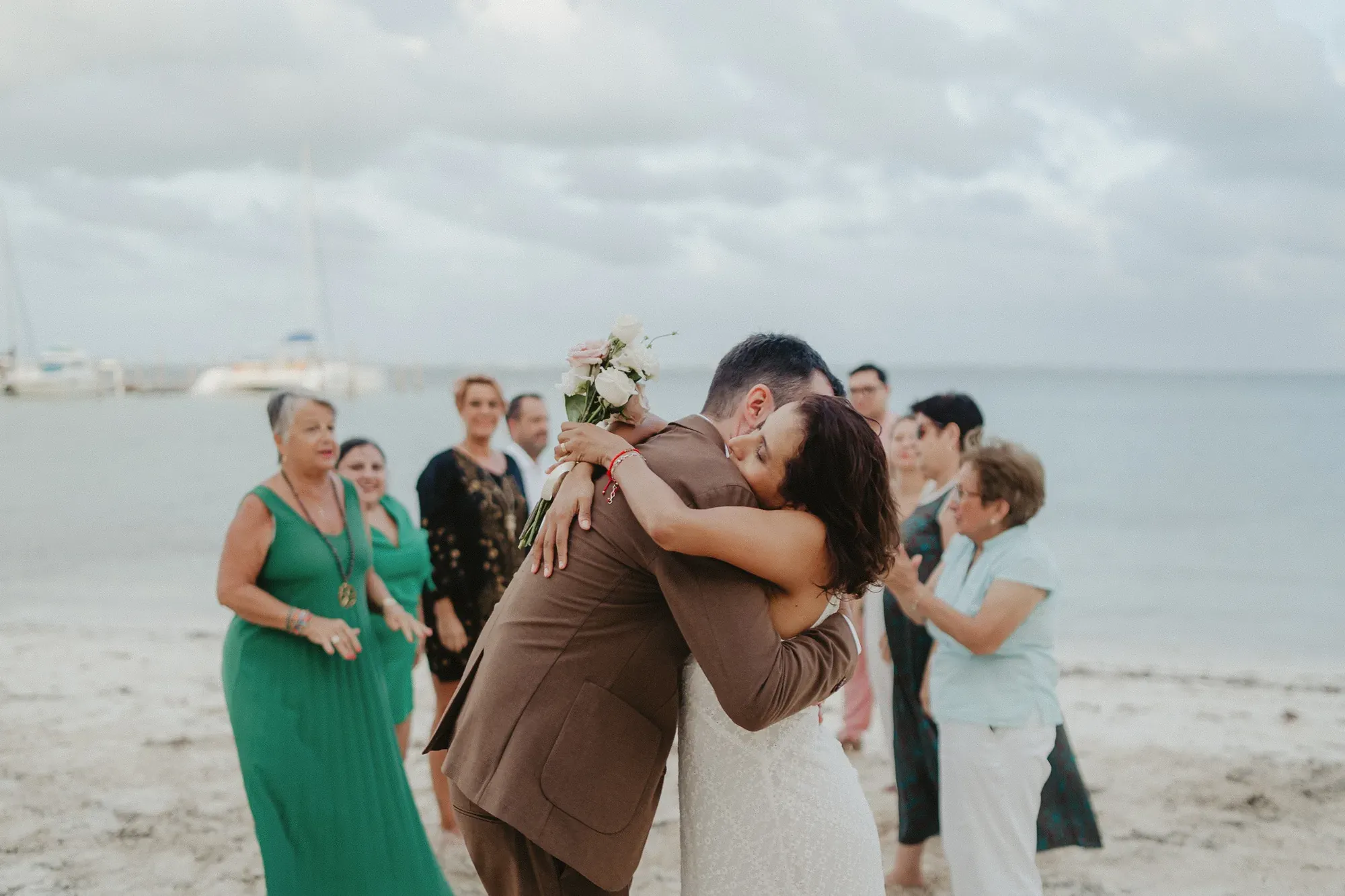 Couple embracing after their beach ceremony